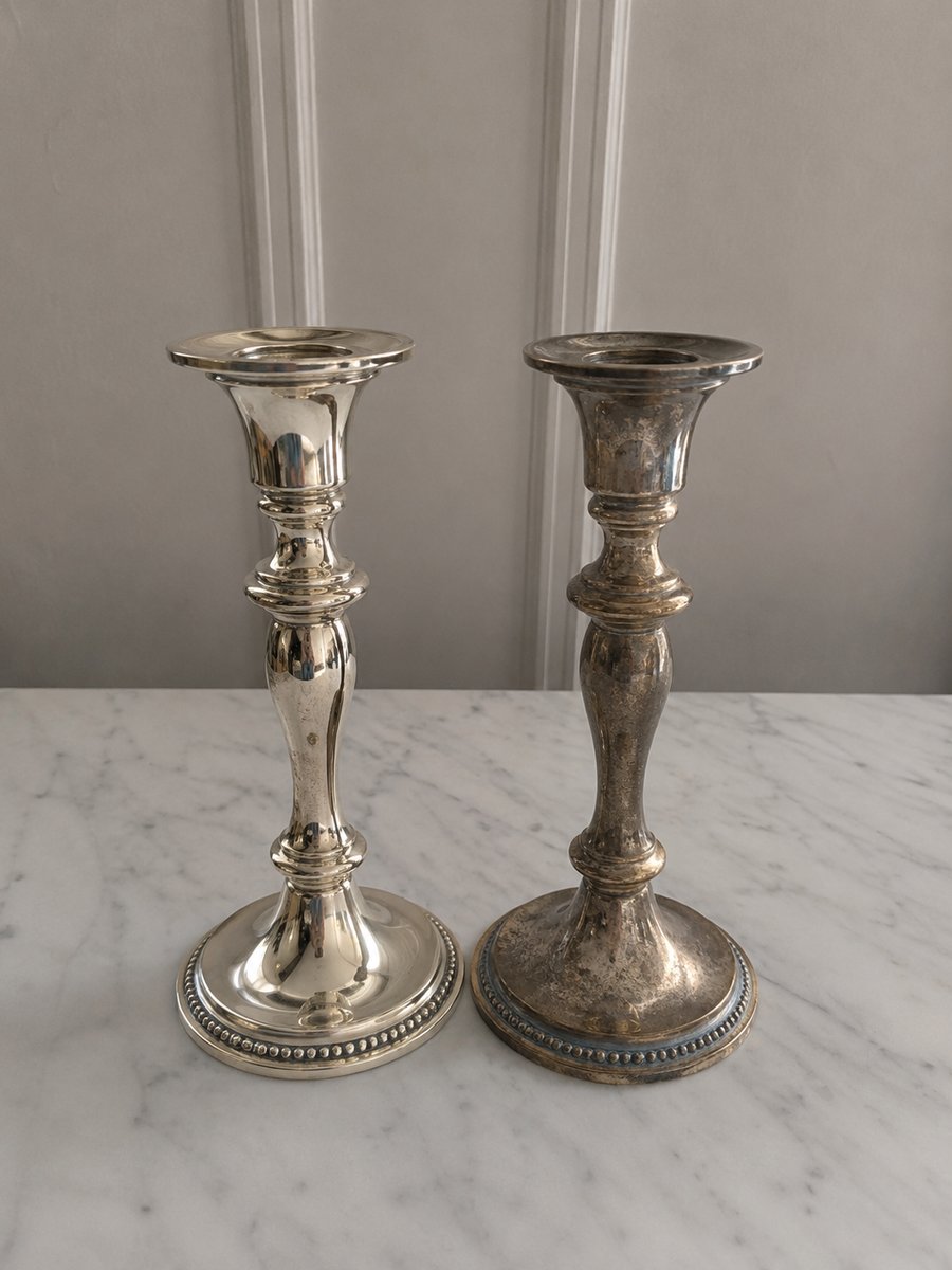Silver candlesticks, one polished and one tarnished