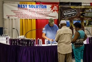 Customers at the Best Solution booth at an indoor show