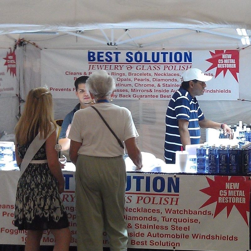 Crowd at the Best Solution booth with C5 metal restorer signs